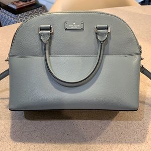 Kate Spade large dome purse in sky blue with handles and crossbody strap.
